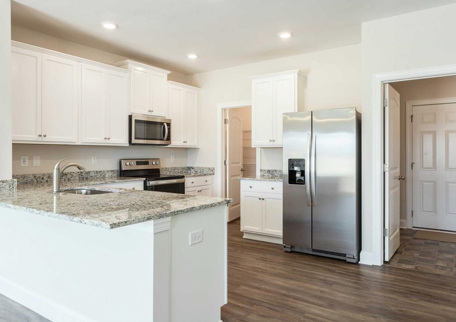Allatoona kitchen with granite finish, stainless steel appliances, and white cabinetry