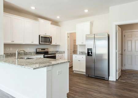 Allatoona kitchen with granite finish, stainless steel appliances, and white cabinetry