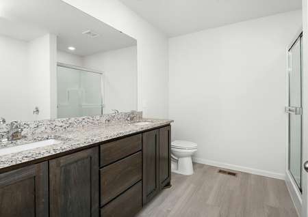 The master bathroom is spacious with a double sink vanity