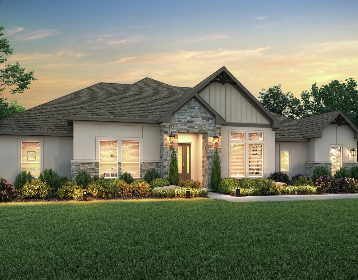 The Stratton plan dusk rendering with stucco and stone accents.