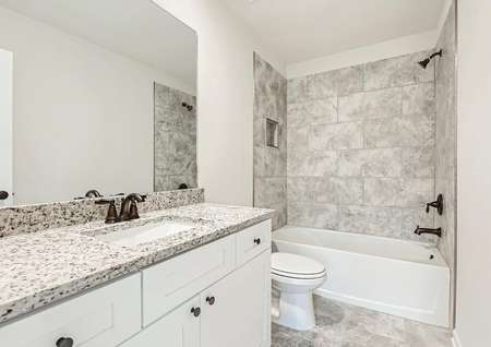Secondary bathroom with a dual shower and bath tub, lined with stunning tile. 
