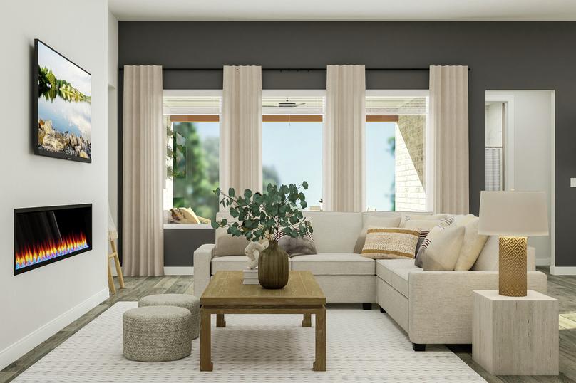 Rendering of the living room with a
  sectional couch in front of a wall of windows. The space also has a coffee
  table, two poufs, a side table with lamp and a fireplace.