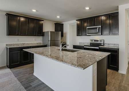 Stunning kitchen outfitted with designer upgrades such as stainless steel appliances and granite countertops.