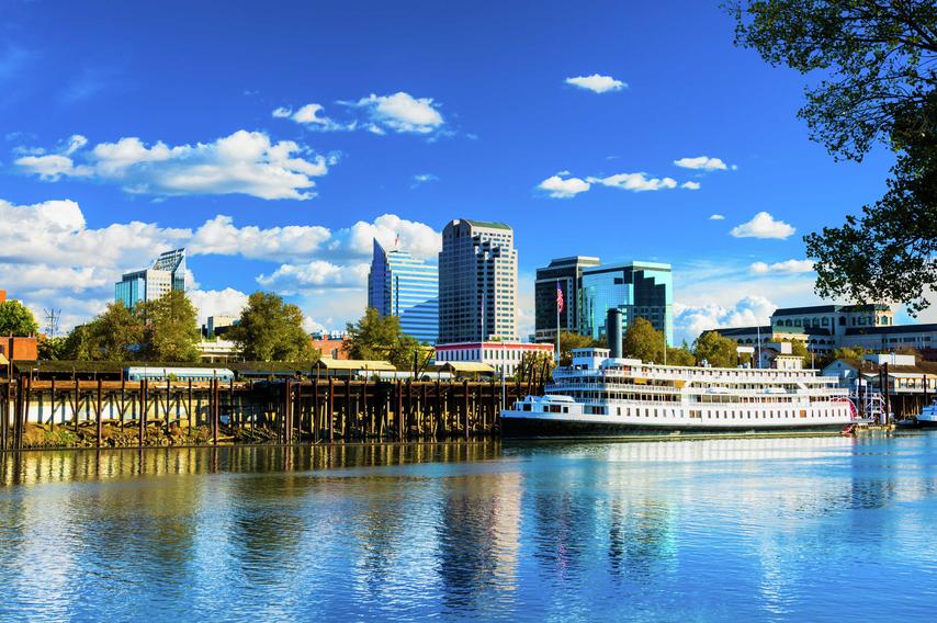 Sacramento, California Delta King riverboat on the Sacramento River showing the city's skyline in the background