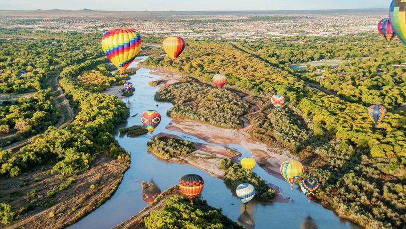 Hot air balloons floating over the Rio Grande near Albuquerque, New Mexico.