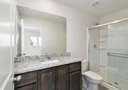 The spare bathroom is spacious with a large vanity