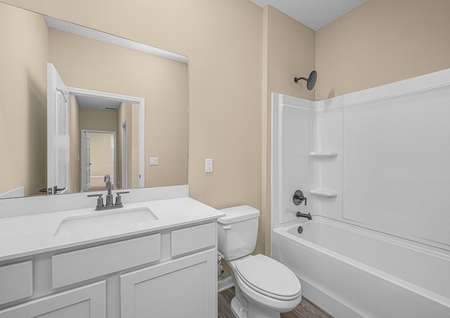 The spare bathroom has a spacious vanity and is ready to host your guests