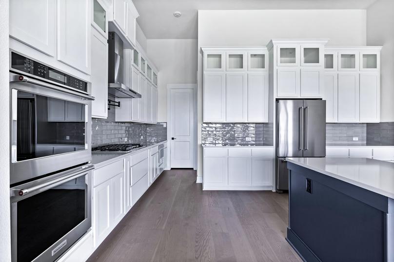 Exquisite details include stainless appliances, oversized wood cabinetry and sprawling countertops.