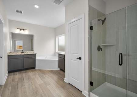 Master bathroom with dual sink vanity, a soaking tub and a step in shower