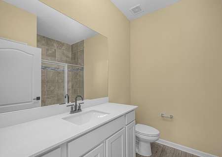 The master bathroom has a large vanity and step-in shower