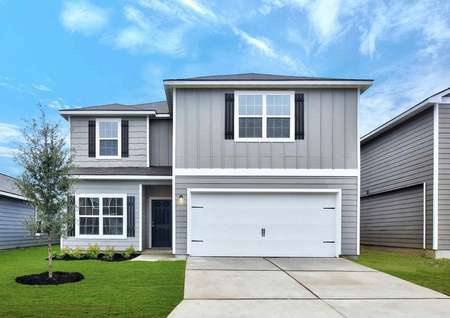 Travis finished house with two stories, grey siding with dark grey shutters, and white two car garage