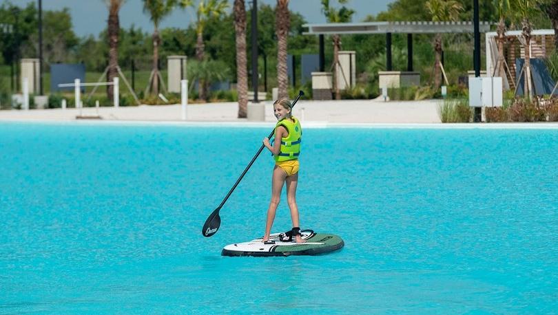 Girl paddle boarding on Lago Mar lagoon