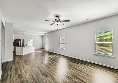 Naturally lit, open layout of the kitchen, family room, and dinning room