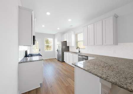 Kitchen with granite countertops and white cabinets