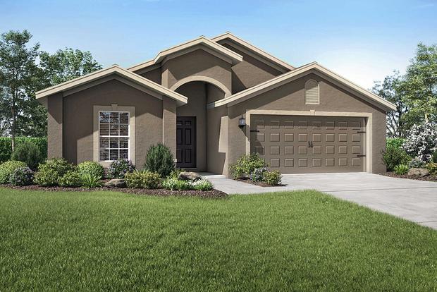 Exterior view of the Estero floor plan model with a two-car garage and a beautifully landscaped front yard.