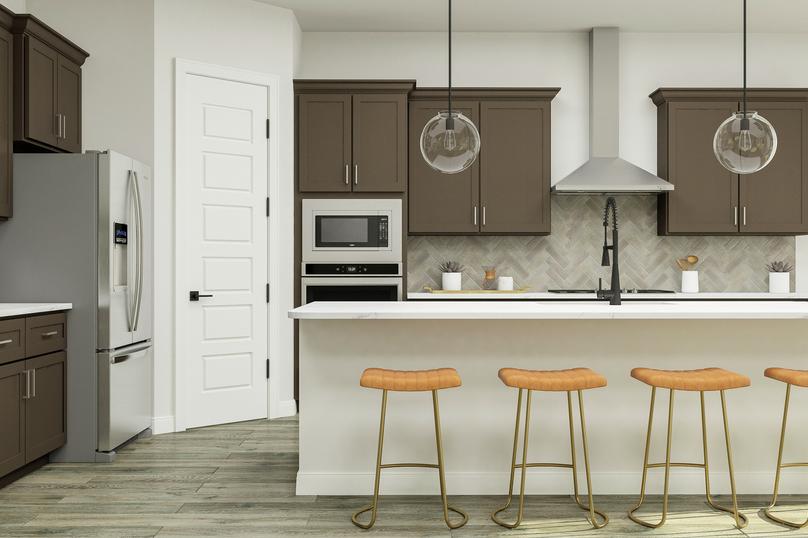 Rendering of the designer kitchen of the
  McAlester floor plan featuring grey cabinetry, stainless-steel appliances,
  and a large island with barstools.