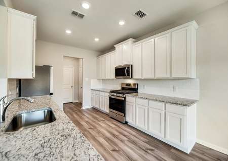 The kitchen comes with stunning, white cabinetry and a full suite of stainless steel appliances.