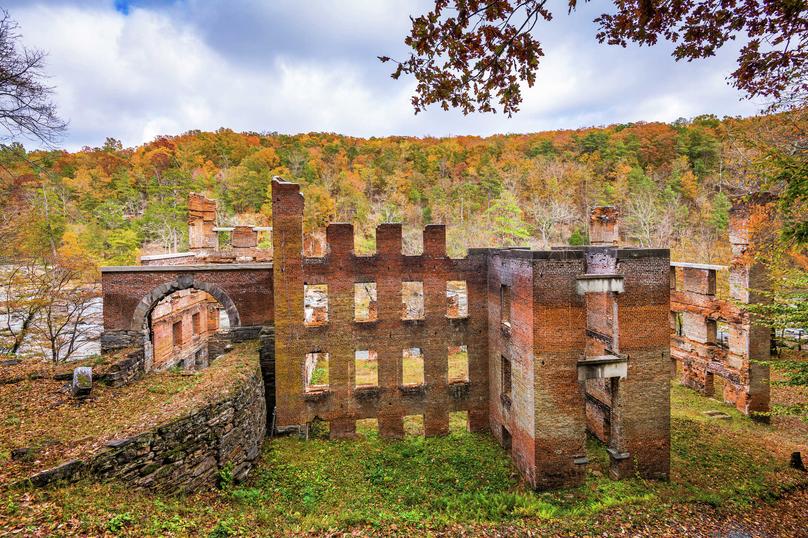 Atlanta, Georgia Sweetwater Creek State Park Old Mill ruins with remnants of a brick factory and hills filled with Autumn trees in the background