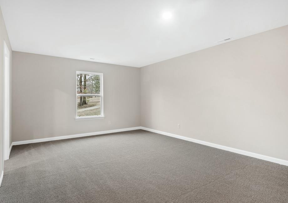 The master bedroom has carpet and a window.