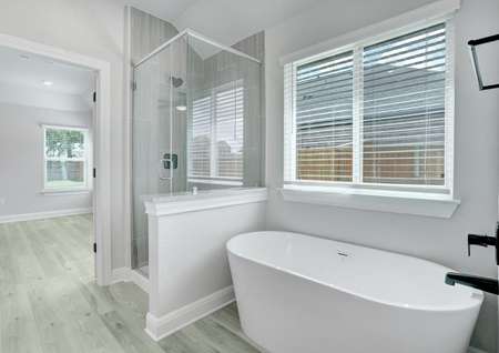 Luxurious master bath with a soaking tub and walk-in shower, making it feel like a spa.