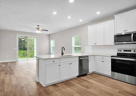 An open-concept floor plan allows for the kitchen to overlook the home's entertainment space. 