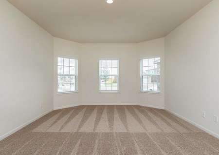 Cypress front room with multiple windows, carpeted flooring, and overhead recessed light