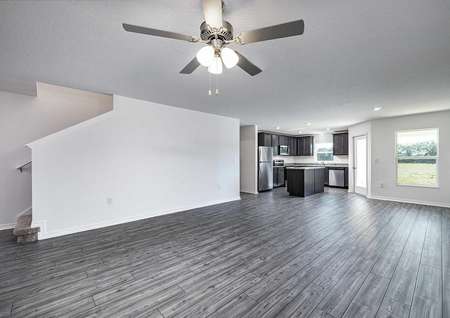 Open-concept entertainment space overlooking the stairs, family room, covered back patio and spacious kitchen area. 