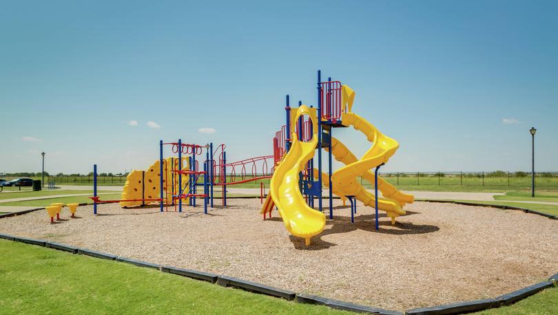 Patriot Estates new home community kid's playground with yellow slides