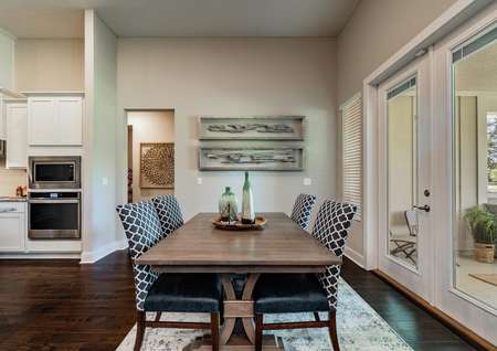 Dining area with table, chairs and art.