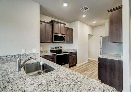 Beautiful granite countertops and stainless steel appliances fill this chef-ready kitchen.