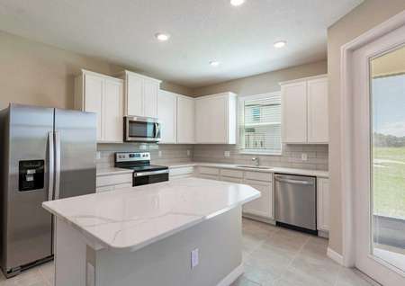 A kitchen with quartz countertops, recessed lighting and 42