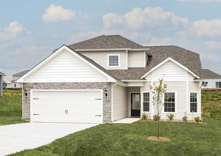 Front elevation photo of the two-story Chantilly plan by LGI Homes with white siding and gray stone.
