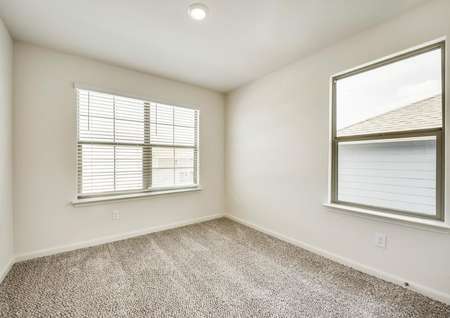 Two sizable windows fill this secondary bedroom with great natural lighting.