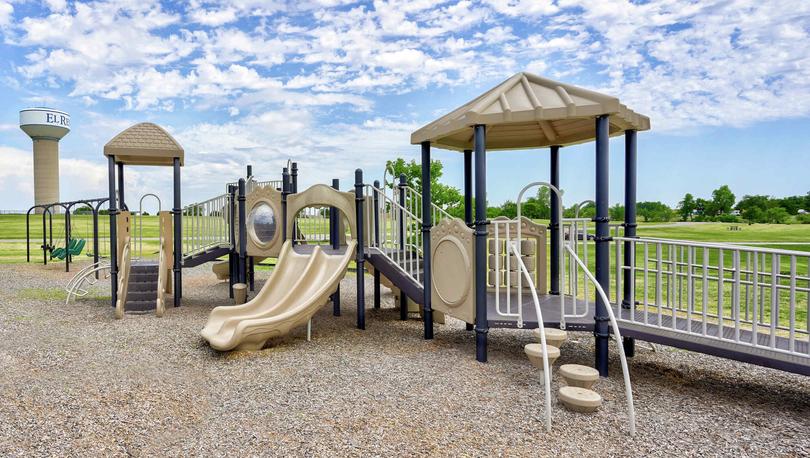 Crimson Lake Estates new home community children's playground with plenty of equipment, slides, and shading