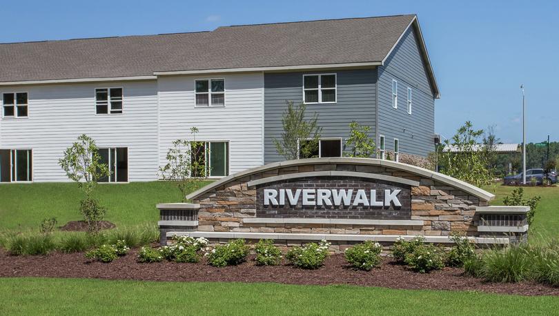 Riverwalk entry monument with landscaping around it. 