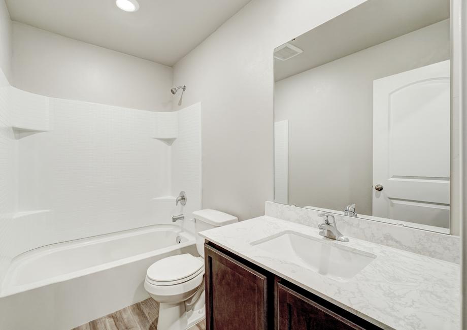 A full bathroom with a bathtub and plenty of countertop space.