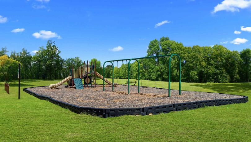 Finlay Farms community playground with grass surrounding it.