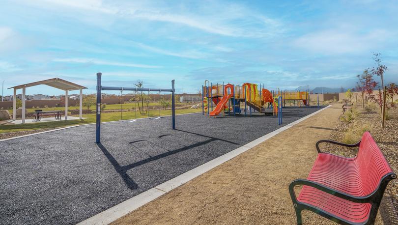 Community park with a playground and a swing set and a covered gazebo