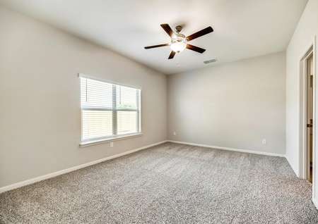 The master suite offers great natural light and a ceiling fan.