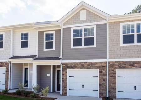 The two-story Bradford A elevation with an attached garage and stone accent detailing.