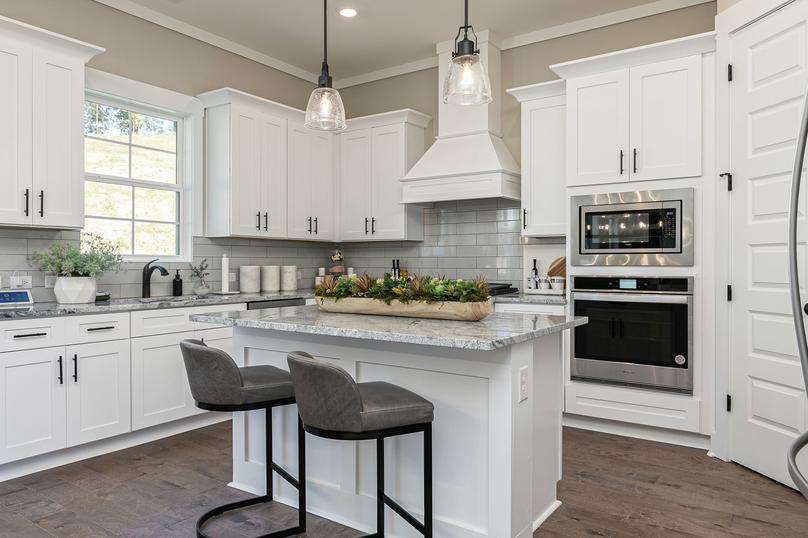 Angle shot of kitchen with granite island.