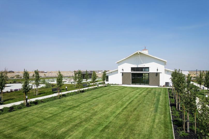 The Events Barn at Club Liberty with sliding barn doors, green grass and trees.