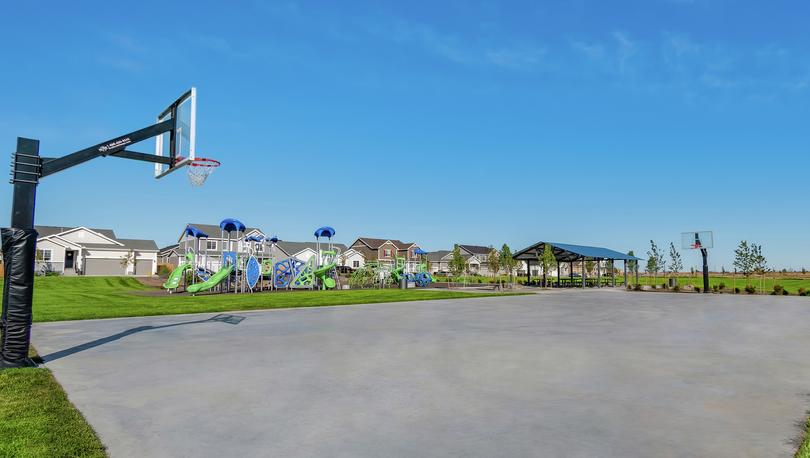 Basketball court with playground in the background. 