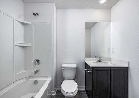 The spare bedroom features its own full bathroom with a bathtub, toilet and sink. 