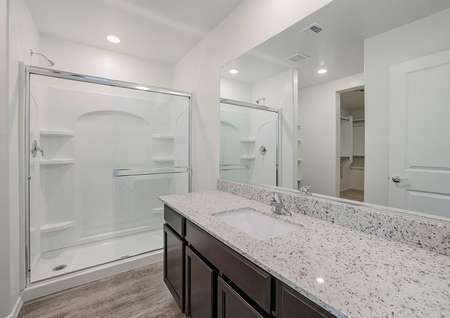 Master bathroom with granite countertops, recessed lighting, and walk-in shower.