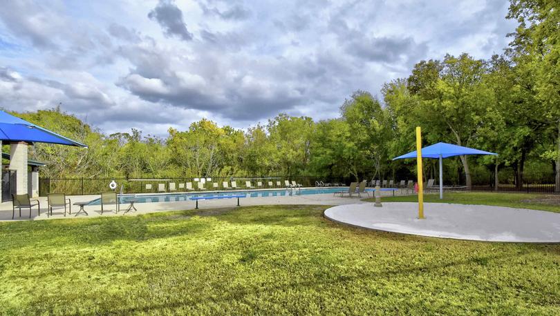 Bunton Creek new home community park with swimming pool and green grass 