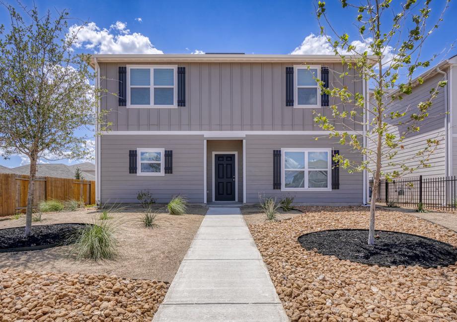 Exterior of the Young plan with professional front yard landscaping.