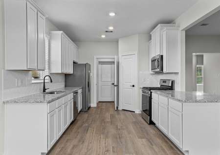 Chef ready kitchen with white cabinets and stainless steel appliances