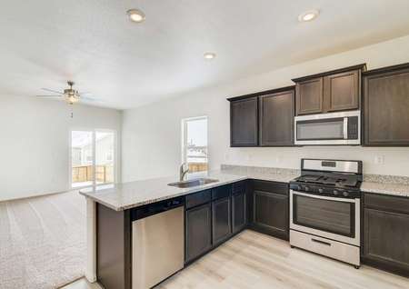 Beautiful kitchen with tall espresso cabinets and stainless steel appliances