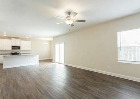 Hartford great room with wood flooring, white trim, and ceiling fan